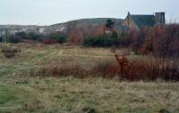 This is the site of the North British Railway's Addiewell terminus looking north west towards Addiebrownhill and Stoneyburn. It has been landscaped here but the line ran from bottom right to run round the left side of the church and on to a junction by East Whitburn. The line continued east as a private line worked by the NBR to service various works. The church has lost its spire since the 1960s and Addiewell has lost its industry.<br><br>[Ewan Crawford 06/12/2003]