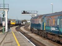 Class 57 No. 57316 waits to take the four coaches of the Arriva loco hauled service, just arrived from Holyhead, to Canton Depot as ECS and will follow the Pacer that is heading for Radyr on the City line. <br><br>[Mark Bartlett 18/09/2009]