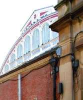 Part of the west end of Helensburgh Central station, with its striking fanlight, being enjoyed by the usual gathering of pigeons. Photograph taken in April 2005 through the (locked) metal gates at the entrance to the alley from Princes Street. [See image 3728]  <br><br>[John Furnevel 23/04/2005]