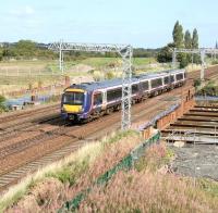 A Glasgow Queen Street - Edinburgh Waverley service runs past Saughton on 9 September 2009. Construction work on the foundations for the bridge that will eventually carry the Edinburgh Tram lines over the railway at this location is well under way.<br>
<br><br>[John Furnevel 09/09/2009]