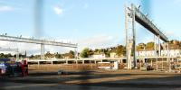 View of the new maintenance sidings from the south. The laid track, overhead lights and platforms can be seen here. [Vertical lines are due to the photograph being taken through a chain link fence.]<br><br>[Ewan Crawford 26/09/2009]