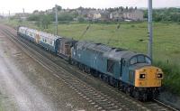 The now preserved 40135 hauls a refurbished Wirral Line Class 503 EMU south along the WCML near Coppull heading back to Merseyside from Horwich Works. This working travelled out from Horwich to Preston [See image 19617] before reversing to run south to Birkenhead via Warrington and Ellesmere Port. Note the way the unit has been formed in the train so the (possibly modified and dedicated) brakevans were able to couple to the inner ends of the cars but not the non-standard front coupling.  Photo by Steven Brindley. Additional information about these workshop trains by Steven Brindley and Neville Parry.<br><br>[Mark Bartlett 29/06/1981]