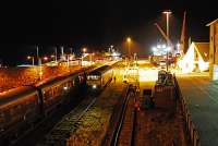 The Royal Scotsman on arrival at Kyle. The locomotive has been re-fueled and is seen running round. The railway pier sees a lot of (non railway) use, wind turbines are being unloaded from a vessel on the right and two days later that side of the pier was entirely covered with timber.<br><br>[Ewan Crawford 29/09/2009]