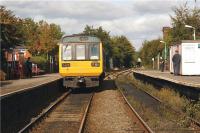 142034 has just terminated at Shaw and Crompton on 1 October 2009 and will shortly continue to the turnback siding on the Rochdale side of the station. Photo taken from the level crossing looking towards Rochdale with the footbridge immediately above the photographer.<br><br>[John McIntyre 01/10/2009]
