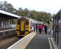 For some reason three (non-successive) Fife Inner Circle services on <br>
Saturdays are currently being diverted so that rather than return to <br>
Edinburgh they go back round the circle again as far as Kirkcaldy via the otherwise little-used north to east curve at Inverkeithing, making them a true circular service.On 26 September passengers at <br>
Dunfermline Town seek reassurance from the driver that they are to catch this one and change at Dalgety Bay for Edinburgh.After more than two years in Scotland 158 868 is still in its silver Alphaline livery but with ScotRail transfers applied. It is one of the few 158s with a 400hp engine rather than the standard 350hp unit.<br><br>[David Panton 26/09/2009]