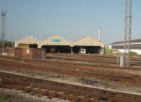 The Arriva running shed at Cardiff Canton, as seen from a passing Barry Island service. It is mid-morning but the depot is almost empty illustrating the intensive valley services throughout the day. The (City) line in the immediate foreground runs round the left side of the depot and then crosses the main line on its way to Radyr.<br><br>[Mark Bartlett 18/09/2009]