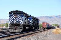 A trio of Montana Rail Link (MRL) EMD SD70ACe's nos 4314, 4312 and 4315 follows an eastbound BNSF freight through the yard at Livingston, Montana in September 2009. The trio has just helped a freight up the western slope of the Bozeman Pass and provided braking assistance on the eastern descent. The locomotives will take up position at the eastern end of the yard to await the arrival of the next westbound freight. When this train arrives it will be split in two and the three MRL loco's will be inserted in the middle and the train reassembled ready to tackle the climb to the 5,800 feet high summit.<br>
<br><br>[Andy Carr 21/09/2009]