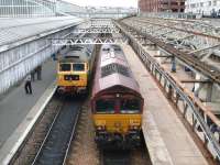 A Compass tours charter train from Crewe stands in platform 6 at Aberdeen station on 25 September 2009. Two-tone green class 47 no D1916 remains on the train as 66016 runs back through platform 7 in readiness to take the tour back south. There should have been two Class 47s involved but one had disgraced itself at Lancaster on the outward journey and D1916 had hauled the train (13 coaches and the dead Class 47) over Shap to Carlisle where the failure was removed and replaced by 66016.<br>
<br><br>[B A Cairns 25/09/2009]