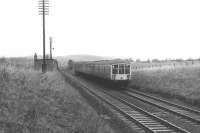 A Derby Lightweight DMU on a Glasgow - Carlisle service passes the Lanarkshire & Ayrshire bridge remains at Lugton in April 1969. [With thanks to Stewart Duthie]<br>
<br><br>[Colin Miller /04/1969]