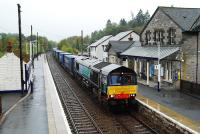 A Stobbart's container train comes to rest at Blair Atholl in very heavy rain. The train had a bit of a wait before the northbound passenger service passed it. The signalman gave the driver a wave which conveyed 'tough luck, you might as well turn off your engine'. (Meanwhile off to the left the Blair Atholl sidings forest continues to grow.)<br><br>[Ewan Crawford 02/10/2009]