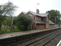 Plumley Station looking west towards Chester. Building now used as private offices with signal in grounds at either end. Home on west end by station approach path, and distant on east end as in shot. <br><br>[David Pesterfield 01/09/2009]