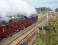 Plenty of steam from 6233 <I>Duchess of Sutherland</I> as she heads north on a sunny but cool morning at Woodacre, near Scorton, on the Crewe to Carlisle leg of the <I>Royal Scot</I> steam excursion. This view taken from the footbridge that replaced the original level crossing when the line was upgraded for 125mph running. This was one of the last main line runs for the Duchess before its <I>ticket</I> expired but she was subsequently granted an extension and, repainted from maroon to black, continued on the main line during 2010 [See image 29245].<br><br>[Mark Bartlett 10/10/2009]