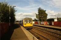 Looking east towards Oldham as 142060 departs from Hollinwood on a Manchester Victoria to Shaw and Crompton service on 01 October 2009. The train is about to cross the M60 Manchester orbital motorway.<br><br>[John McIntyre 01/10/2009]