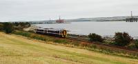 A northbound Sprinter approaches Invergordon from the south. This was the service which only runs as far as Invergordon from Inverness. Invergordon Harbour continues to be busy supporting the oil industry - there are five rigs in this shot (the jack up legs of the furthest to the left are only just visible). I wish I could do a from left to right naming of them - anyone like to help me out?<br><br>[Ewan Crawford 29/09/2009]