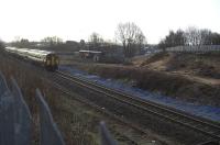 Taken from the footpath which runs along the north side of the railway, looking south-west. The 0758 Hrs Sprinter (156513?) has just departed Kilmarnock for Glasgow Central. Johnnie Walker siding headshunt in the foreground (reopening unlikely with Diageo pulling Johnnie Walkers out of Kilmarnock). Kilmarnock No 1 signalbox was on the bank just about where the front end of the sprinter is passing (steps down the banking from the footpath are still there, but well buried in the brambles!).<br><br>[Robert Blane 06/03/2009]