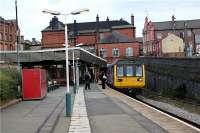 142013 calls at Wigan Wallgate platform 1 on route to Kirkby from Manchester in the early evening of 15 October 2009.<br><br>[John McIntyre 15/10/2009]