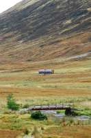 A Kyle bound morning train approaches Glen Carron Platform (closed) from the east. Trains look very small in this landscape.<br><br>[Ewan Crawford 29/09/2009]