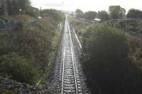 Looking East straight down the Barrhead line to Kilmarnock station in (unfortunately) bright morning sunshine after rain, from the Western Road bridge. Johnnie Walker siding headshunt to left, old Dalry line and Long Lyes to right, and advance of the machines in the distance.<br><br>[Robert Blane 08/10/2009]