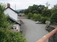 The old Low Level station, now a pub, and the former trackbed seen from the end of the platform at Builth Road High Level looking south to Builth Wells. There used to be a lift at this point, allowing passengers and their luggage to transfer between the Central Wales line and that from Newtown to Brecon, which passed under the bridge here but closed in 1962.<br><br>[Mark Bartlett 17/09/2009]