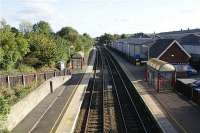 Looking south from the road bridge at Adlington station on 16 October 2009. The narrowness of the platforms, especially at the south end, is quite unusual. To stand behind the yellow line involves keeping very close to the fence, something that is advisable with the speed of the trains that do not call here.<br><br>[John McIntyre 16/10/2009]