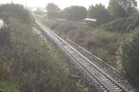 Looking East straight down the Barrhead line to Kilmarnock station in (unfortunately) bright morning sunshine after rain, from the Western Road bridge. Johnnie Walker siding headshunt to left, old Dalry line and Long Lyes to right, and advance of the machines in the distance.<br>
The station tower can be seen in the distance as can and contractors' machinery.<br><br>[Robert Blane 08/10/2009]