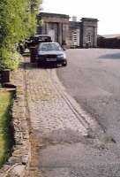 Probably the best preserved relics of this short-lived (21 years) electric tramway through open countryside are the rails set in cobbles in front of Ashby station. That Rover 400 has hit hard times, too. Notice the points just in front of the car.<br><br>[Ken Strachan 18/06/2005]