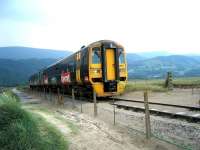 An Arriva Trains Wales 158 service in <I>Ginsters</I> advertising livery photographed on the Cambrian Coast line near Barmouth Viaduct on 3 July 2006.<br><br>[Bruce McCartney 03/07/2006]