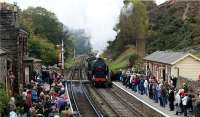 A southbound service enters Goathland station having worked hard on the climb from Grosmont during the North York Moors Railway's 'War Weekend' on 18 October 2009. Windows at the station have had tape applied and many of the people on the platform are wearing 1940s style clothing including military uniforms.<br><br>[John McIntyre 18/10/2009]