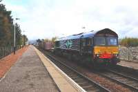 DRS liveried 66434, going south with a short container train, waits at Kingussie on 26 October 2009 for a northbound passenger train to clear the single line section from Dalwhinnie.<br><br>[John Gray 26/10/2009]