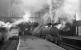 B1 4-6-0 no 61173 is about to take a train out of Bradford Exchange in the 1960s. The station, built as a joint project by the Lancashire & Yorkshire and Great Northern Railway, effectively operated as two separate stations for much of its life. Modelled on London Kings Cross, it had two 450ft long arched roofs, with each company operating five platforms and separate booking offices, an arrangement that lasted until early 1940. The station eventually closed in 1973 with trains operating from a much simplified station located 185m further south behind the camera. The old Exchange station building was eventually demolished in 1976 and its 1973 replacement was renamed Bradford Interchange in 1983.<br><br>[Robin Barbour Collection (Courtesy Bruce McCartney) //]