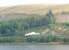 A Brecon Mountain Railway service, headed by an American outline tender locomotive, heads north from Pontsticill alongside Torpantau reservoir. The narrow gauge BMR follows the track bed of the old standard gauge Brecon and Merthyr line, which closed in 1962.<br><br>[Mark Bartlett 19/09/2009]