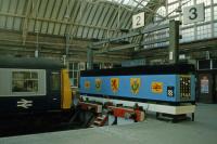 The imaginatively decorated platform terminus at Helensburgh Central as recorded on February 9th 1985. The poster on the right hand end of the blue cladding warns that playing 'Station Invaders' is a potentially fatal game. Since then, both the Class 303 units and computer games have moved on<br><br>[Mark Dufton 09/02/1985]