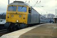 The curved platform at Manningtree gives the driver of Norwich-bound 47 605 a good view of proceedings on April 8th 1985. Electrification work was nearing completion for the 'switch-on' to Ipswich and Harwich. The remaining section to Norwich was completed the following year and Class 47s were destined to be replaced by Class 86s on London-Norwich services.<br><br>[Mark Dufton 08/04/1985]