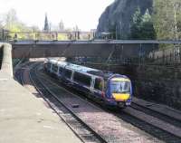 A commuter service runs alongside the Castle Rock in Princes Street Gardens in April 2009.<br><br>[John Furnevel 07/04/2009]