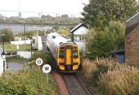 With strong winds and rain battering the shores of the Beauly Firth, an afternoon train off the Far North line rumbles over Clachnaharry swing bridge as it nears its ultimate destination on 3 October 2009. The Kessock Bridge, carrying the A9, dominates the background.  <br><br>[John Furnevel 03/10/2009]