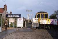 The Midland and Great Northern Joint station at Sheringham became a passenger terminus in 1964 but by 1966 the premises and associated level crossing were considered too expensive to maintain. The solution was to construct a smaller halt (opened in January 1967) on the Cromer side of the crossing, as shown here with a Norwich-bound service on May 2nd 1976. Many of the visible features were surviving items from the former station, including the signage, platform seats, lighting columns and, somewhat unexpectedly after nearly a decade as an unstaffed halt, the luggage handcart. The original station still operates, but now under the auspices of the North Norfolk Railway.<br><br>[Mark Dufton 02/05/1976]