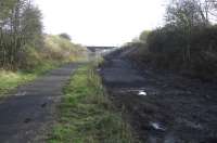 Looking East towards Kilmarnock station from the cycle path on the old Dalry line. The new buffers will be roughly at the end of the fence line, whilst the path is about to be slewed to make way for the sidings. The old buffers which survived the line's closure and subsequent conversion to a cycle path (they were at the bottom of the ramp down from the road) have been removed, which is a shame as they were a good reminder of the path's former use.<br><br>[Robert Blane 31/10/2009]