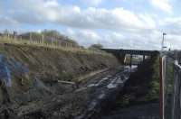 Looking back towards Kilmarnock station from the bottom of the cycle path ramp down on to the old Dalry line, Western Road bridge in background and old platform/retaining wall to left. The Up loop passed through the left hand opening below the bridge.<br><br>[Robert Blane 31/10/2009]