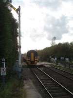 As the Leicester train leaves the end of Rolleston's platform it passes the distant signal for Fiskerton, controlled from the Midland box there [See image 25987]. The crossing here at Rolleston is operated by a crossing keeper working out of a lineside hut under the supervision of Staythorpe Crossing box. Fiskerton and Rolleston stations are very close together and 158777 had barely got under way before it was shutting off for the next halt.  <br><br>[Mark Bartlett 23/10/2009]