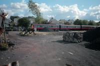 A DMU arrives at East Kilbride station. The view is across the former coal yard and sidings. The sidings have since been lifted, the coal yard has closed and the site has been built on. The station remains open but with only one track.<br><br>[Ewan Crawford //1987]