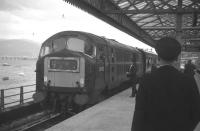 D6103, one of the ill-fated NBL Type 2s, pulls into the old Fort William station c 1968. The NBLs had only a short spell on the West Highland and Oban lines, replacing the BRCW Type 2s which had superceded steam in the early 60s. The notorious unreliability of the NBL locos soon led to the return of the BRCW Type 2s, which continued to dominate West Highland and Oban line operations until the arrival of the Class 37s in the late 1970s.<br>
<br><br>[David Spaven //1968]