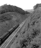 The Bristol and Exeter Railway cuts through the end of the Mendips in a  deep cutting crossed by a brick arch known locally as Devil's Bridge. A Hymek is hauling a train north towards the junction of the Weston loop at Uphill Junction. Sources differ as to whether a station was built here but never used.<br><br>[John Thorn /09/1962]