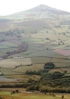 Dwarfed by the 1900 feet of the Sugar Loaf, <I>King George V</I> tackles Llanvihangel Bank just north of Abergavenny on its way towards Hereford with a steam special in 1983.<br><br>[John Thorn //1983]