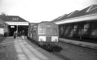 An Edinburgh-bound DMU at the attractive North Berwick terminus in 1969. The line was already a 'basic railway' with one-train working over the single track from Drem, but services subsequently fell back to just a handful of trains a day after reprieve from closure (1971?), and sadly the station buildings were thereafter razed to the ground. A shame that the nowadays more enlightened attitude to redundant station buildings hadn't been around in those days - but at least the service is now utterly transformed, with electric trains now running hourly through the day.<br><br>[David Spaven //1969]