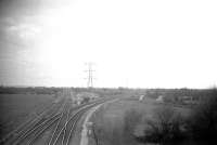 Worle Junction is at the Bristol end of the Weston-super-Mare loop.  Looking west in 1960, the Taunton line bears left and the Weston loop right. At  the end of the lane, centre right, is the site of Worle station. The  Weston loop is now single (plans to re-double it have recently been  abandoned) and there is a new Worle station a mile nearer Bristol.<br><br>[John Thorn //1960]