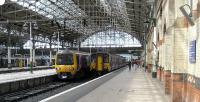 Platforms 1 and 2 at Manchester Piccadilly at lunchtime on 19 July 2008 with Northern services to Sheffield in Platform 1 formed by DMU 150270 and to Hadfield/Glossop in platform 2 with EMU 323231. Note the drip trays between the bullhead rail on platform 2. This side of the station was once wired for the 1500v DC electric service to Sheffield Victoria which passed through Hadfield on the Woodhead route. Today Hadfield is as far as trains travel on that route with the line now electrified at 25 KV. The Sheffield train is now diesel powered and takes the Hope Valley route.<br><br>[John McIntyre 19/07/2008]