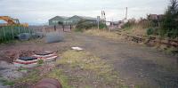 The site of Fairlie Pier station was being cleared and turned into parkland in 1987. The pier line ran off to the left, the disused line to the right was Fairlie Admiralty Siding. The Largs line is off to the right. View through chainlink fence.<br><br>[Ewan Crawford 28/09/1987]