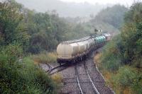 Before running on to Fort William Junction a freight from Glasgow reverses into the Lochaber Aluminium Smelter with bauxite. The oil tanks are just going along for the trip. And boy was it chucking it down.<br><br>[Ewan Crawford 28/09/2009]