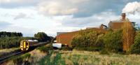 An Aberdeen - Inverness service passes Norbord Highland's factory at Dalcross in September 2009. This factory was rail served with the siding being west of the former station.<br><br>[Ewan Crawford 30/09/2009]