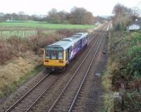 <I>Pleasant Pleasington</I>. Looking east towards Cherry Tree from the overbridge at Pleasington station the open countryside on the outskirts of Blackburn can be seen. 142009 is pulling away on a Colne bound stopping service.<br><br>[Mark Bartlett 13/11/2009]